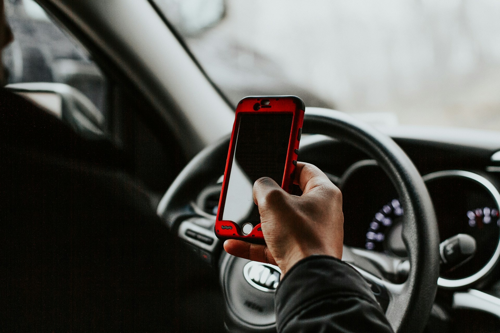 Driver checking a smartphone while driving
